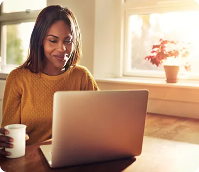 Happy USCI Student working on a laptop